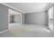 Neutral living room featuring plush carpeting and a partial view of the adjacent dining area at 1075 Pebble Bend Dr, Grayson, GA 30017