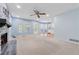 Bright living room with fireplace, ceiling fan, and access to a modern kitchen at 1075 Pebble Bend Dr, Grayson, GA 30017