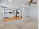 Bright, open-concept living area with fireplace, carpeting, and adjacent kitchen views at 1075 Pebble Bend Dr, Grayson, GA 30017