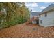 View of backyard with foliage and a back deck that is connected by wooden stairs to the yard at 777 Glen Valley Way, Dacula, GA 30019