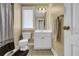 Functional bathroom with a toilet, vanity, mirror, and a shower curtained shower and tile flooring at 777 Glen Valley Way, Dacula, GA 30019