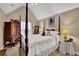 Charming bedroom with a four-poster bed, decorative armoire, and soft lighting creating a cozy atmosphere at 777 Glen Valley Way, Dacula, GA 30019