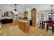 Open kitchen and dining area with wood cabinets, hardwood floors and lots of natural light at 777 Glen Valley Way, Dacula, GA 30019