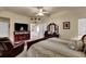 Light-filled main bedroom with carpet, a ceiling fan, and easy access to the en suite bath at 777 Glen Valley Way, Dacula, GA 30019