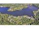 Aerial view of a home nestled within a forest, near a lake or river surrounded by dense trees at 8530 Hightower Trl, Snellville, GA 30039