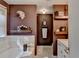 Bathroom featuring double sinks, a soaking tub, floating shelves, and elegant decorative accents for a spa-like experience at 8530 Hightower Trl, Snellville, GA 30039