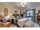 Traditional bedroom with a warm ambiance, featuring vintage decor, a comfortable bed, and a cozy seating area at 8530 Hightower Trl, Snellville, GA 30039