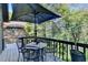 Outdoor deck area with dining table and chairs, surrounded by lush greenery at 8530 Hightower Trl, Snellville, GA 30039