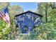 Charming blue home with an American flag, surrounded by lush greenery at 8530 Hightower Trl, Snellville, GA 30039