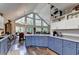 Open kitchen with blue cabinets, high ceilings, and modern appliances at 8530 Hightower Trl, Snellville, GA 30039