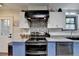 Kitchen features stainless steel appliances, range hood, and mosaic backsplash at 8530 Hightower Trl, Snellville, GA 30039