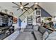 A living room featuring a blue accent wall, vaulted ceilings, a ceiling fan, and a comfortable gray sectional sofa at 8530 Hightower Trl, Snellville, GA 30039
