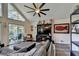 Comfortable living room with vaulted ceilings, a ceiling fan, and sliding door access to deck at 8530 Hightower Trl, Snellville, GA 30039