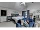 A bright main bedroom featuring a seating area, neutral tones, a ceiling fan, and a double door leading outdoors at 8530 Hightower Trl, Snellville, GA 30039