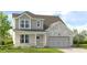 Charming two-story home featuring a covered porch and attached two-car garage at 1763 Fawlocke Run, Loganville, GA 30052