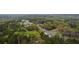 An aerial view showing the residence, and a tree filled area bordering a road at 5747 S Gordon Rd, Austell, GA 30168
