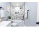 Well-lit bathroom features a shower over tub with marble tile surround and modern fixtures at 5747 S Gordon Rd, Austell, GA 30168