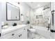 Beautiful bathroom with a shower over the tub and a white marble patterned tile surround at 5747 S Gordon Rd, Austell, GA 30168