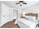 Bright bedroom features hardwood floors, closet, ceiling fan, and bed with a tufted headboard at 5747 S Gordon Rd, Austell, GA 30168