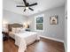Inviting bedroom with hardwood floors, neutral decor, and natural light from a bright window at 5747 S Gordon Rd, Austell, GA 30168