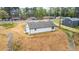 Aerial shot of this residence showcasing the gravel driveway, backyard, wooded fencing, and neighborhood at 5747 S Gordon Rd, Austell, GA 30168