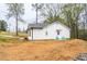 Charming home with white siding, well-manicured lawn, two chairs on the front porch, and a gravel driveway at 5747 S Gordon Rd, Austell, GA 30168