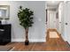 Inviting hallway featuring wood grain flooring, neutral paint, and easy access to multiple rooms at 5747 S Gordon Rd, Austell, GA 30168