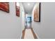 Hallway features neutral walls, wood floors, white trim, artwork, and leads to a blue accent wall in a dining area at 5747 S Gordon Rd, Austell, GA 30168