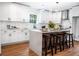 Beautiful white kitchen with a center island, stainless steel appliances, and modern pendant lights at 5747 S Gordon Rd, Austell, GA 30168