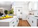 Bright kitchen boasts white cabinets, quartz countertops, and a pantry for ample storage at 5747 S Gordon Rd, Austell, GA 30168
