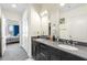 Modern bathroom features double sinks, granite countertops, and access to bedroom at 1100 Howell Mill Nw Rd # 711, Atlanta, GA 30318