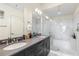 Modern bathroom features double sinks, granite countertops, and a shower/tub with white subway tile at 1100 Howell Mill Nw Rd # 711, Atlanta, GA 30318