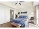 Bright bedroom featuring a ceiling fan, neutral walls and decor, and a view into the adjacent bathroom at 1100 Howell Mill Nw Rd # 711, Atlanta, GA 30318