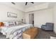 Spacious bedroom features carpeted floors and a queen bed with stylish decorations and an accent chair at 1100 Howell Mill Nw Rd # 711, Atlanta, GA 30318