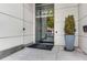 Building entrance with address, glass doors, a modern exterior, and professional landscaping near the entrance at 1100 Howell Mill Nw Rd # 711, Atlanta, GA 30318