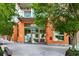 Modern building exterior featuring an orange facade, large windows, lush greenery, and inviting street access at 1100 Howell Mill Nw Rd # 711, Atlanta, GA 30318