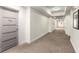 Neutral hallway with patterned carpet, multiple entry doors, and subtle lighting creating a quiet atmosphere at 1100 Howell Mill Nw Rd # 711, Atlanta, GA 30318