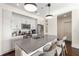 Bright kitchen featuring white cabinets, stainless steel appliances, an island with bar seating and stylish pendant lighting at 1100 Howell Mill Nw Rd # 711, Atlanta, GA 30318