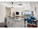 Open-concept living room boasts large windows with city views, a comfortable blue sofa, and modern decor at 1100 Howell Mill Nw Rd # 711, Atlanta, GA 30318