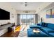 Open living room with hardwood floors, sliding glass doors, and modern furnishings at 1100 Howell Mill Nw Rd # 711, Atlanta, GA 30318