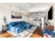 Open-concept living room flows to the kitchen, featuring a sectional sofa, modern art, and hardwood floors at 1100 Howell Mill Nw Rd # 711, Atlanta, GA 30318