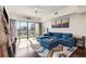 Open living space with hardwood floors, blue sectional, and city views at 1100 Howell Mill Nw Rd # 711, Atlanta, GA 30318