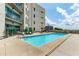 Enjoy the building's outdoor pool with lounge chairs on a sunny day at 1100 Howell Mill Nw Rd # 711, Atlanta, GA 30318