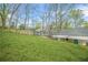 View of the home's backyard showing a large lawn and exterior of the home at 1910 Thompson Ave, East Point, GA 30344