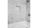Close up of bathtub and tile shower featuring a modern shower head and niche at 1910 Thompson Ave, East Point, GA 30344