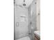 Walk-in shower featuring gray tile surround, a shower niche and modern fixtures at 1910 Thompson Ave, East Point, GA 30344