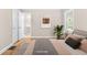 This staged bedroom features warm hardwood floors, and a soothing color palette to create a relaxing retreat at 1910 Thompson Ave, East Point, GA 30344