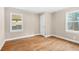 Neutral bedroom with hardwood floors and two windows offering natural light at 1910 Thompson Ave, East Point, GA 30344