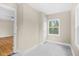 Bedroom with hardwood floors, neutral paint, brick accent wall, and a window at 1910 Thompson Ave, East Point, GA 30344