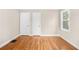 This bedroom offers hardwood floors and natural light from two windows at 1910 Thompson Ave, East Point, GA 30344